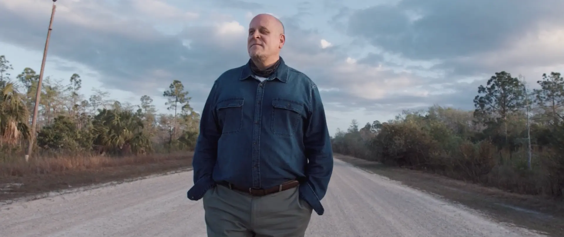 Chris Carrier standing on a rural road in the Florida Everglades
