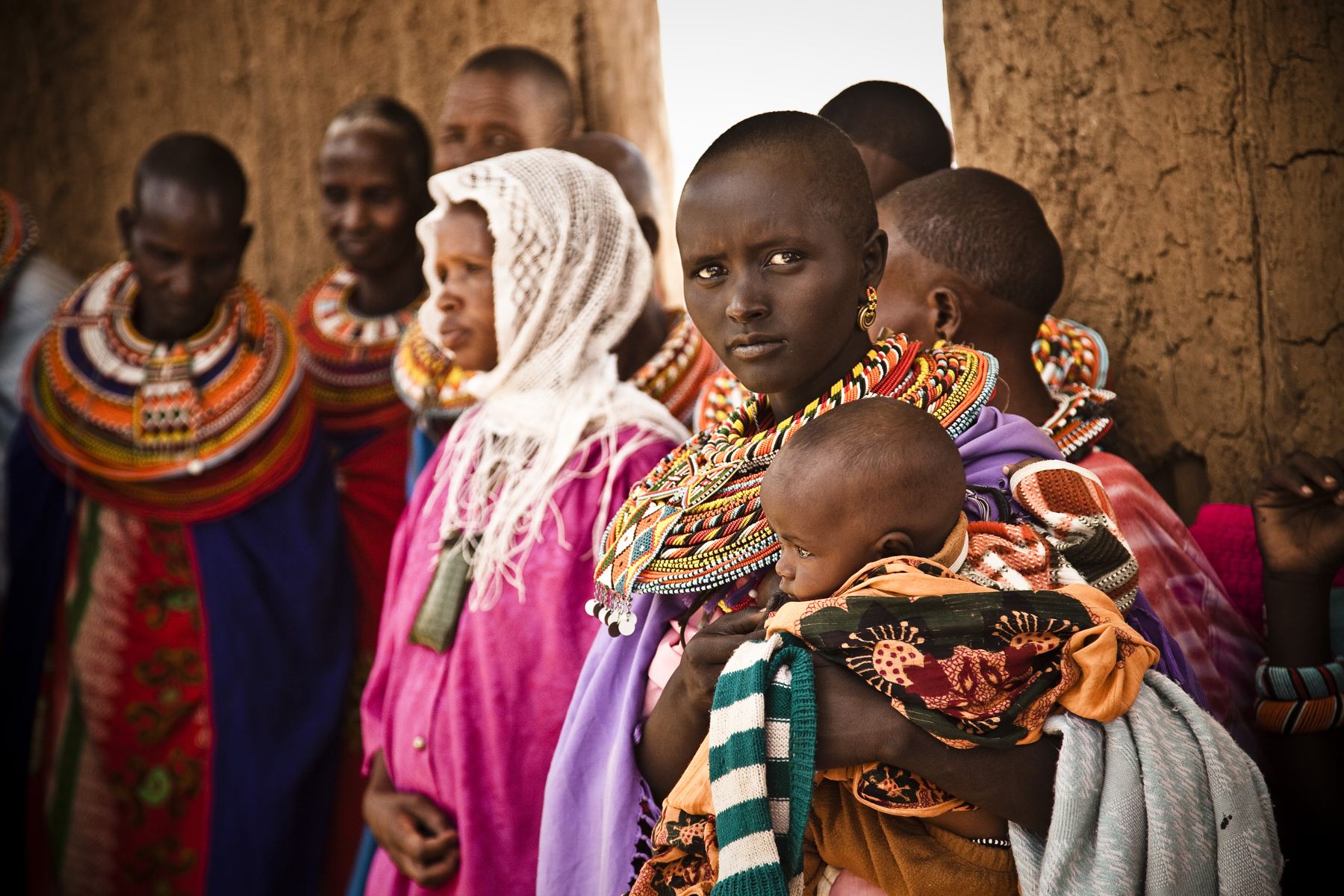Samburu mothers in beaded collars holding their children